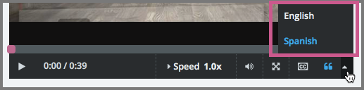 The video player with the language menu selected to show English and Spanish as transcript options